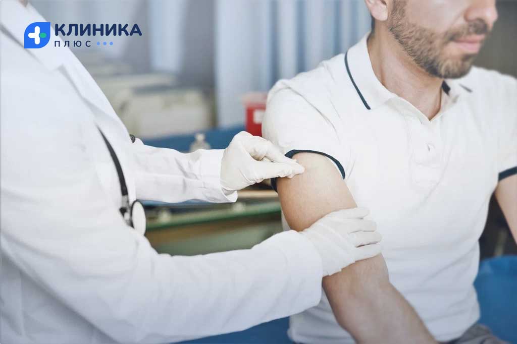 Врач протирает руку пациента ваткой